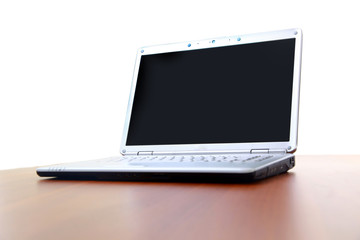 Fototapeta premium Modern laptop isolated on white with reflections on glass table.