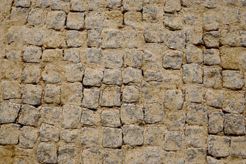 Granite cubes laid in rows and strewed by sand