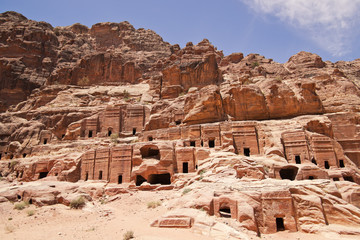 Wide view of large cliff side tomb carved from the beautiful ric