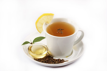 a cup of green tea with honey and lemon