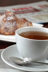 Morning tea with freshly baked croissant and newspaper