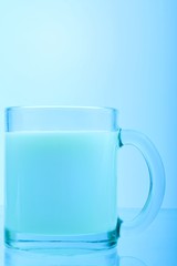 Blue toned glass of milk