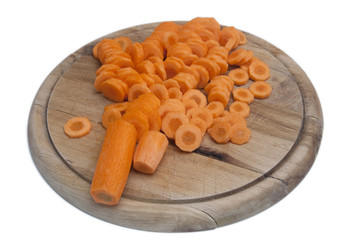 carrots on a wooden plate isolated on white