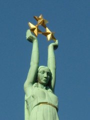 Fototapeta premium Woman's sculpture, holding tree golden stars