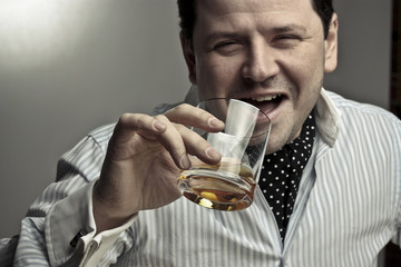 Handsome man with a glass of cognac.