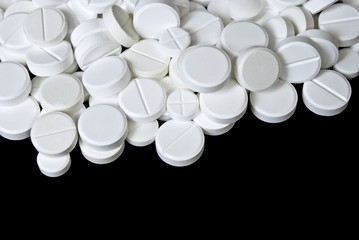 Whitepills scattered on the black background