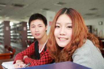 asian boy and girl studying in library