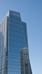 Fototapeta na wymiar Blue Office Tower with Round Building Reflection