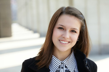 Fototapeta premium beautiful young girl near library