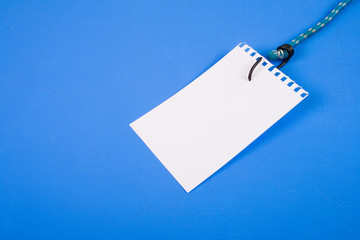 The pure leaf of a paper is pinned on a hook.