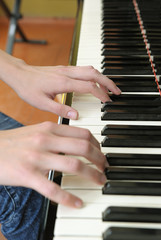 Fototapeta premium Hands above keys of the piano