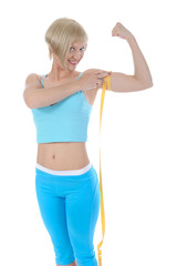 Beautiful athlete measure biceps.