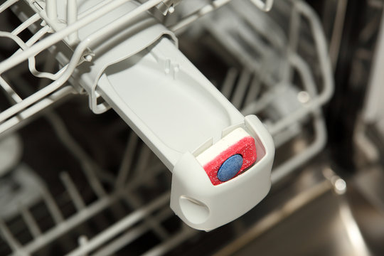 Close-up Of Tablet In Dishwasher Detergent Box