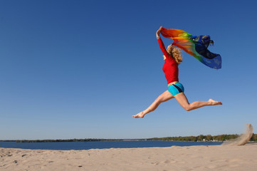 WOMAN JUMPING ON THE BEACH