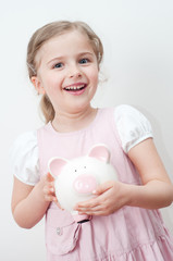 Little girl with piggy bank