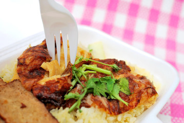 Fork picking up roasted chicken