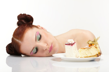 Obraz na płótnie Canvas The beautiful young woman eat tasty cake
