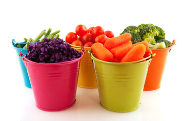 Fresh vegetables in colorful buckets