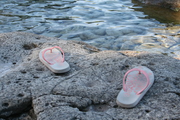 Girl's Flip-flops by the Water Edge