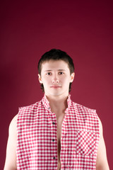 Happy young casual man portrait, isolated on red