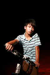 young asian man with bike