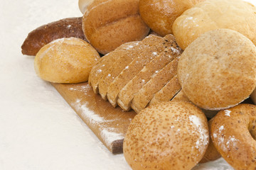 bread on a wooden board sprinkled with flour