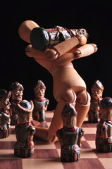 Pieces from an ecuadorian chess set, with a wooden art doll