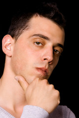 Naklejka premium young man portrait, on a black background