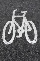 Naklejka na ściany i meble White cycle lane sign on asphalt.