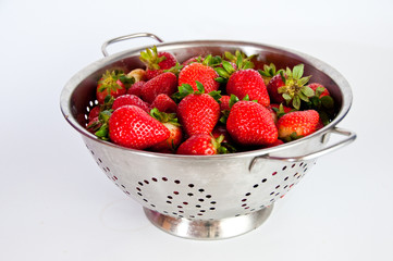 Red strawberries on a colander