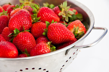 Red strawberries on a colander