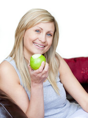 Joyful woman eating an apple
