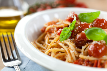Closeup of spaghetti with tomatoes and parmesan