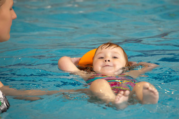 Fototapeta na wymiar mother and daughter in the pool