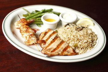 A plate of grilled salmon and prawns.
