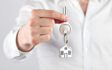giving house key with a keychain house  form