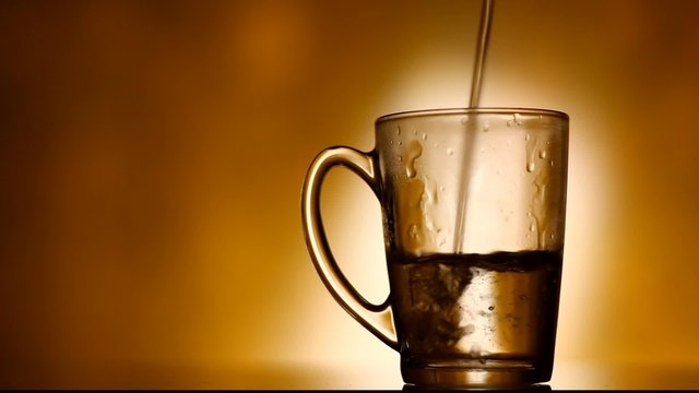 A glass being filled up with pure water