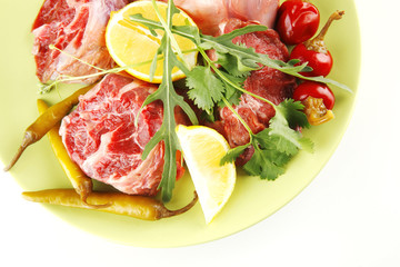 uncooked meat medallion on green