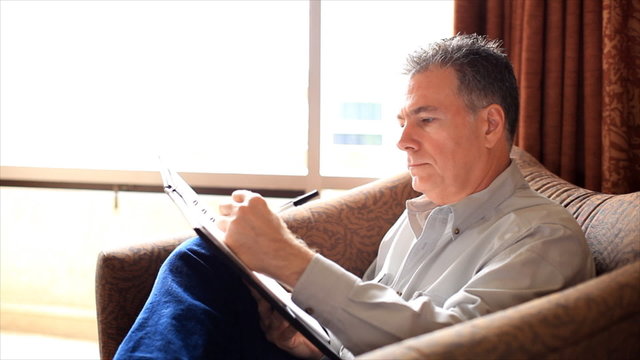 Man Finishing Writing Notes