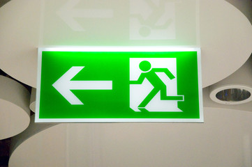 green emergency exit sign in a station