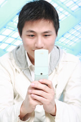 A young, handsome business man on phone at place of work