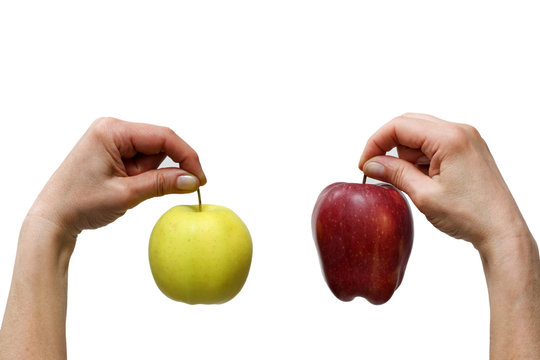 Hands Holding A Yellow And A Red Apple