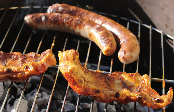 Crisp grilled sausages and ribs on barbecue