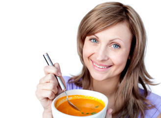 Joyful woman holding a soup bowl