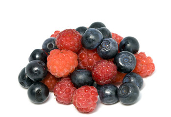 berries of raspberry and bilberry on white background