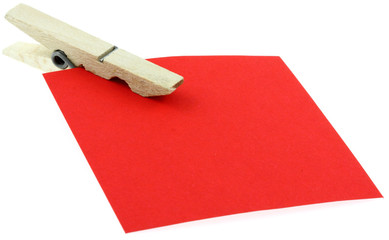 pince à linge en bois sur papier mémo rouge, fond blanc