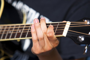 Fototapeta na wymiar playing the gitar with detail on one hand