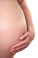 Caucasian pregnant woman holding a belly.