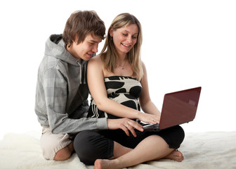 Happy pregnant family with laptop.