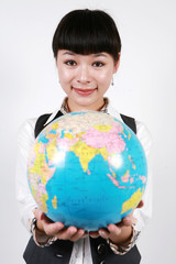 businesswoman holding a globe on white background